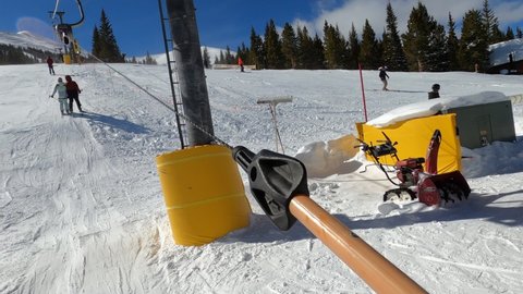 Riding using t-bar ski lift to get on the top of Breckenridge, Colorado