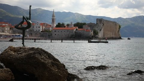 Budva, Montenegro - September 18, 2021: Statue of a dancer on the background of old town Budva, Montenegro. High quality photo