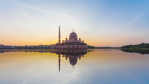 Beautiful cleary sunrise Time Lapse at Putra mosque by Putrajaya lake in Putrajaya, Malaysia at dawn.  Prores 4K