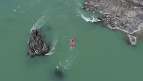 Paddling Through  turquoise Rapids. Whitewater Rafting Teams Descending Raging Rapids.   White Water Rafting on Rough Water. Mountain River Flowing Through A the mountains. video filming from a copter