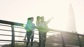 young asian family with two children standing on bridge looking at view outdoors in city park - Powered by Shutterstock - Get 15% off with code: PIKWIZARD15