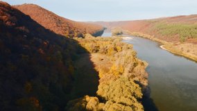 Splendid bird's eye view of the autumn forest in Dniester canyon. Shooting from a quadcopter. Location place Dnister, Ukraine, Europe. Cinematic aerial shot. Beauty earth. Filmed in 4k, drone video.