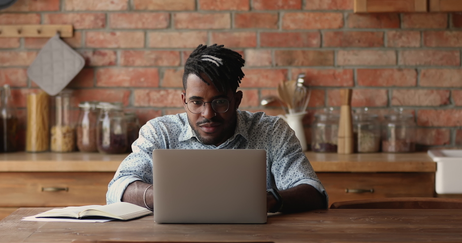 Excited African man winner look at laptop celebrate business success, online victory, get great opportunity, career growth, sit at table at home, read good news got new job offer, reach result concept | Shutterstock HD Video #1082335540