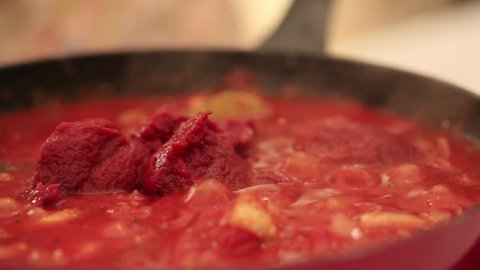 Macro shots of a pot of pasta sauce.