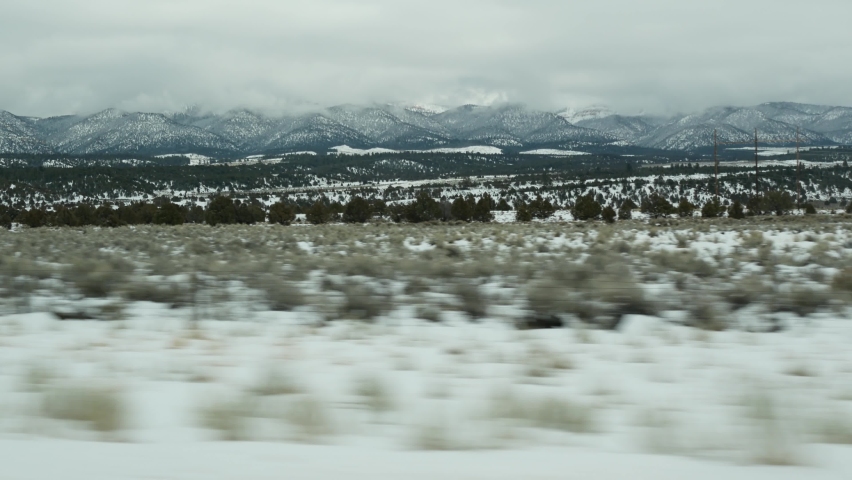 Road trip in USA from Zion to Bryce Canyon, driving auto in Utah. Hitchhiking traveling in America, Route 89 to Dixie Forest. Winter local journey, calm atmosphere and snow mountains. View from car. Royalty-Free Stock Footage #1082340967