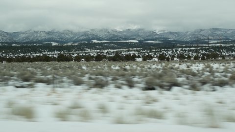 Road trip in USA from Zion to Bryce Canyon, driving auto in Utah. Hitchhiking traveling in America, Route 89 to Dixie Forest. Winter local journey, calm atmosphere and snow mountains. View from car.