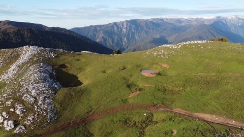 Aerial video from a drone overlooking green meadows in the Caucasian mountains of Abkhazia, on the Arabica plateau. Mountain nature of incredible beauty.