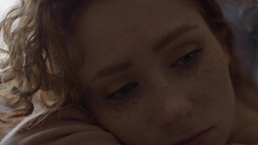 Extreme close up of thoughtful young caucasian woman. Shot with RED helium camera in 8K