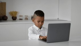 Online Education. Cute Little Black Boy Study With Laptop At Home, African American Male Child Typing On Computer Keyboard While Sitting At Desk In Room, Making Homework, Enjoying Distance Learning