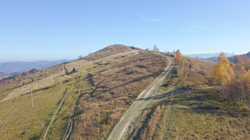 Awesome view on Carpathians hills. Fileds and trees. Country road.