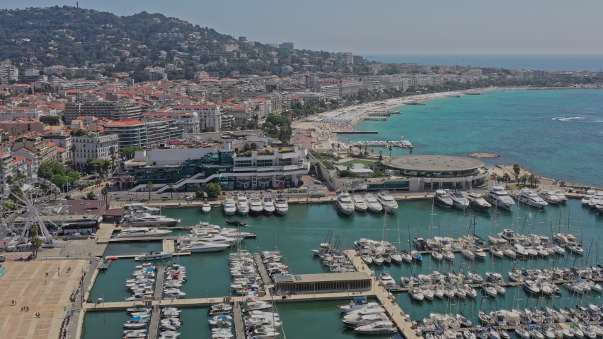 Cannes France Aerial v30 cinematic pan shot capturing popular tourist attraction, vieux port, palais des festivals convention center and beautiful seascape and cityscape - July 2021 Royalty-Free Stock Footage #1082361586