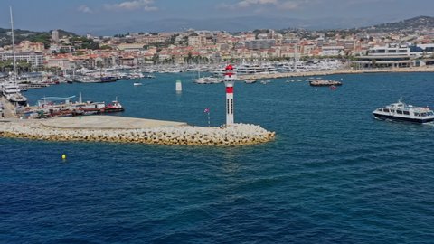 Cannes France Aerial v38 low level drone flying around heliport capturing water activities, croisette beach and cityscape along the coastline - July 2021