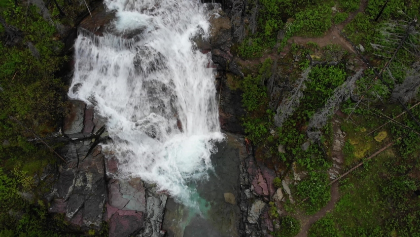 Aerial View of Virginia Falls in Landscape of Glacier National Park, Montana USA, Tilt Up Drone Shot