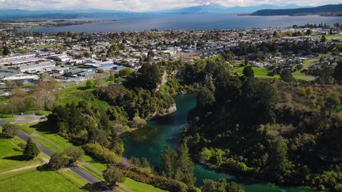Amazing aerial view of Lake Taupo, cityscape of Taupo town on lakefront and Waikato river in New Zealand