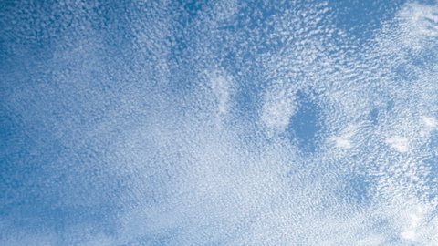 Time lapse of Altocumulus Floccus Clouds moving on blue sky