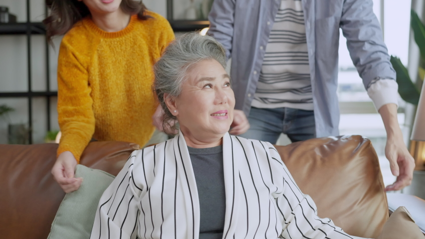 happiness asian family candid of daughter and son hug grandparent mother senior elder mom cozy relax on sofa couch surprise visiting in living room at home,together hug cheerful asian family at home Royalty-Free Stock Footage #1082367268