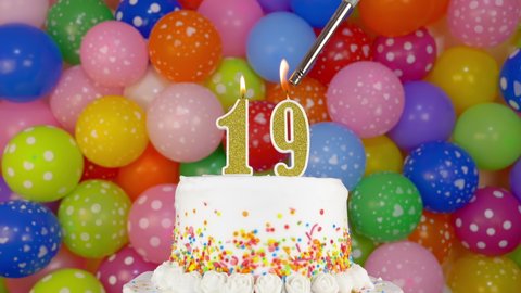 Birthday cake with candles number 19. Cake on a bright festive background of colorful balloons.