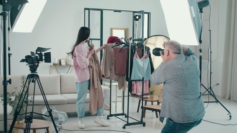 Female model is picking clothes during the photoshoot