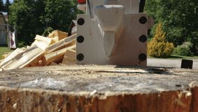 Closer look of the wood cutting machine breaking the big lumbers of logs in the lumberyard in Estonia