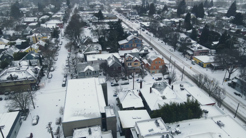 Winter snow storm in Oregon. Panning over snow covered streets, houses and revealing the skyline. High quality 4k footage