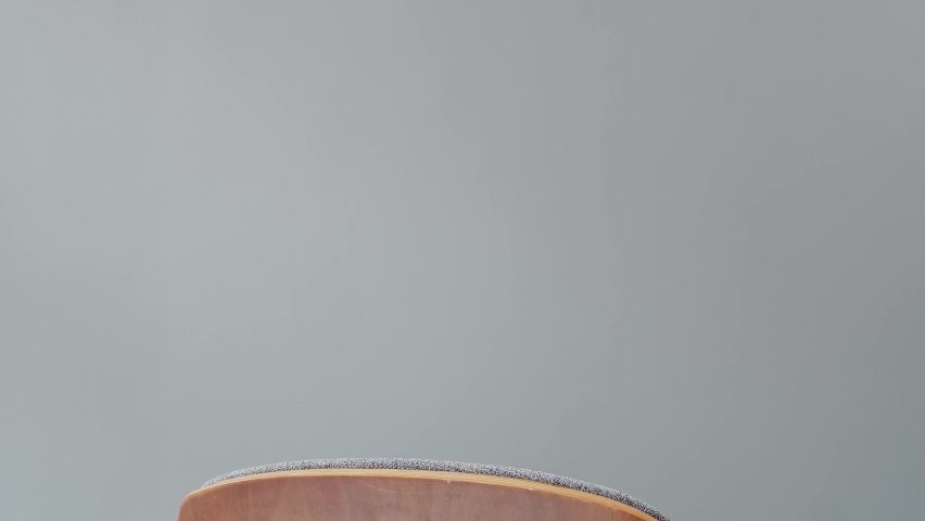 Child emerging in the framing holding on the back of armchair.