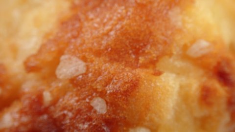 Golden muffin surface extreme close up rotating very slowly stock footage