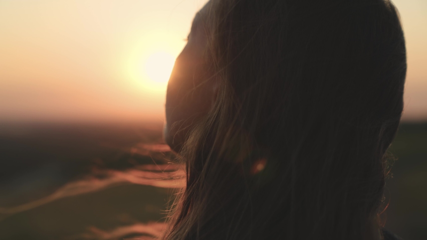 girl prays looking at sunset  Royalty-Free Stock Footage #1082400808