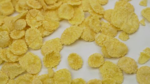 Corn Flakes Are Falling, Close-up, Macro, Slow Motion. Background of  Falling CornFlakes, Isolated. Healthy Breakfast, Healthy Vegetarian Food.