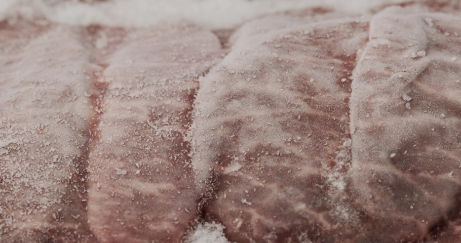 Close-up detail Front view - Time Lapse Ice flakes on Thawed frozen meat steak isolated, Food concept. Royalty-Free Stock Footage #1082409799