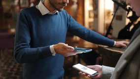 Access mode during a pandemic, restaurant worker scans visitors QR codes for access to restaurant, life during a lockdown, staff using a smartphone for vaccinated visitors identification. - Powered by Shutterstock - Get 15% off with code: PIKWIZARD15