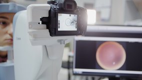 The ophthalmologist examines the patient's eye and then looks into the camera. Close up view footage - Powered by Shutterstock - Get 15% off with code: PIKWIZARD15