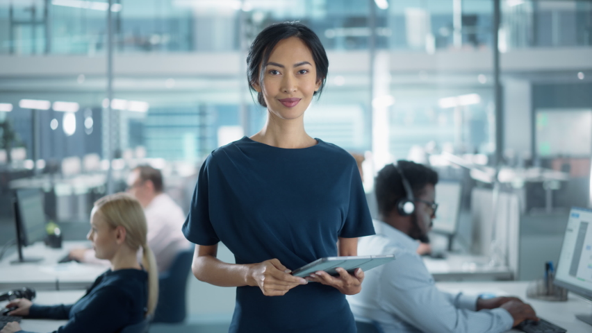 Successful Businesswoman in Stylish Dress Using Tablet Computer, Standing in Modern Diverse Office Working on Financial, Business and Marketing Projects. Portrait of Beautiful Asian Manager. | Shutterstock HD Video #1082416666