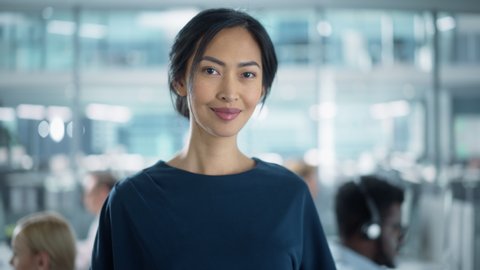 Successful Businesswoman in Stylish Dress Using Tablet Computer, Standing in Modern Diverse Office Working on Financial, Business and Marketing Projects. Portrait of Beautiful Asian Manager.