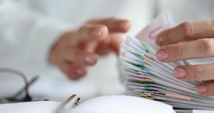Woman sorting paper documents with colorful paper clips closeup 4k movie slow motion