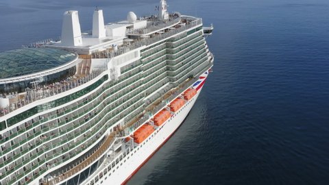 Aerial side view of a cruise ship sailing the ocean or sea on a sunny summer day