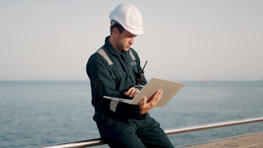Concentrated port inspector supervisor working on laptop computer in ship terminal | Shutterstock HD Video #1082422861