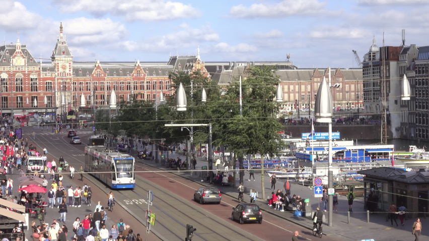 Traffic of Cars, Trams and People Near the Amsterdam Central. Fast Motion
