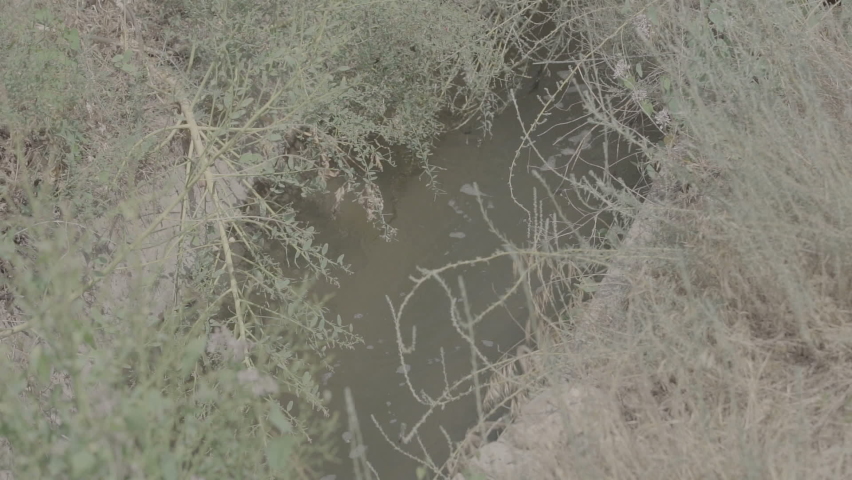 Irrigation channel. Irrigation System in an old village, water channels. Water supply problems. Slow motion 