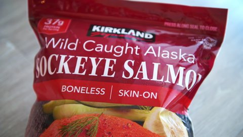 Naples, USA - September 26, 2021: Costco Kirkland brand of sockeye alaskan salmon raw frozen fillets wild caught macro closeup of sign label package boneless skin-on fillet