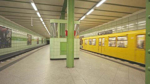 BERLIN, GERMANY - Nov 5, 2021: Metro subway station in Berlin. U-Bahn is an underground metro in Germany. Yellow train at platform.