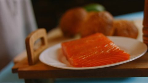 Cut the bread for the burger. Prepare Smoked Salmon Bagel. 4k video