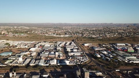 Namibia, Windhoek, 02.05.20: 4K bright summer morning aerial video of Namibia Brewery beer factory and its hangars located in Windhoek Northern Industrial area, Khomas Region, southern Africa