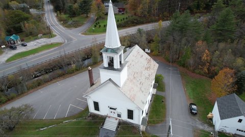 Lake Sunapee United Methodist Church, New Hampshire USA. Aerial View of Landmark and Colorful Autumn Surroundings, Orbit Drone Shot
