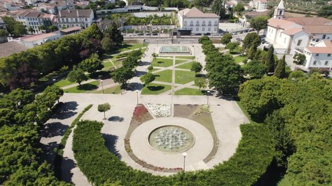 Municipal garden of Castelo Branco in Portugal. Aerial backward tilt up reveal