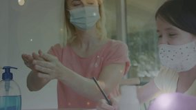 Animation of covid 19 cells over sick caucasian blonde mother and her daughter wearing face masks. global covid 19 pandemic concept digitally generated video. - Powered by Shutterstock - Get 15% off with code: PIKWIZARD15