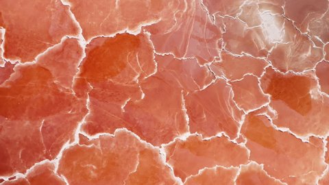 Cinematic overhead orange nature texture looks like meat or prosciutto ham. Beautiful scenic natural background 4K USA.Amazing red pattern top down aerial background with white salt surface texture