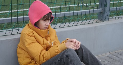 Isolated teen on playground. A teen girl in self isolation stay in loneliness outdoor.