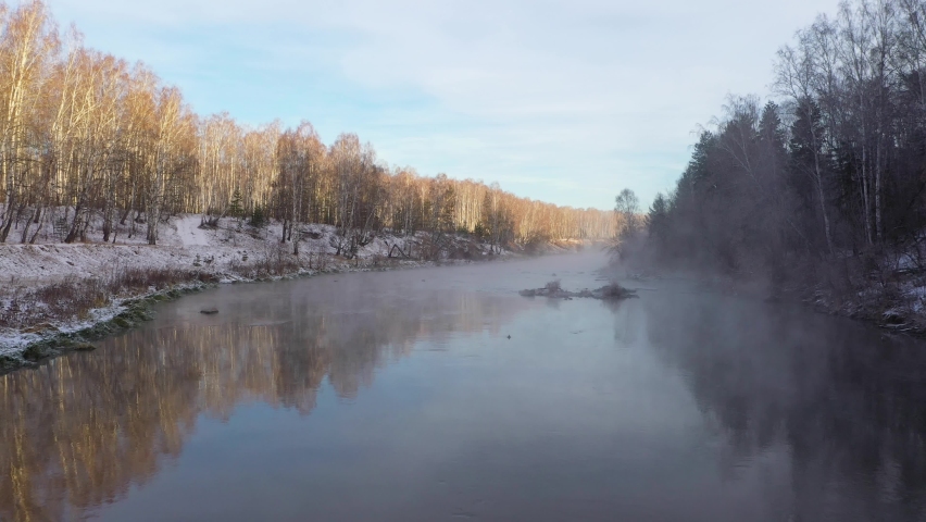 Guy and girl swim on a sap board in winter
