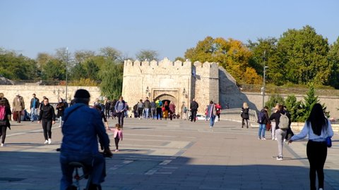 Nis, Serbia - 10 20 2021: View of the city of Nis fortress and new and renovated bridge in perspective full of pedestrians and tourists in a sunny autumn day