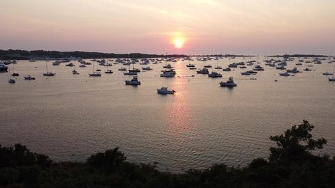 Drone flying over Great Salt Pond in Block Island, RI. Summer sunset with countless boats.